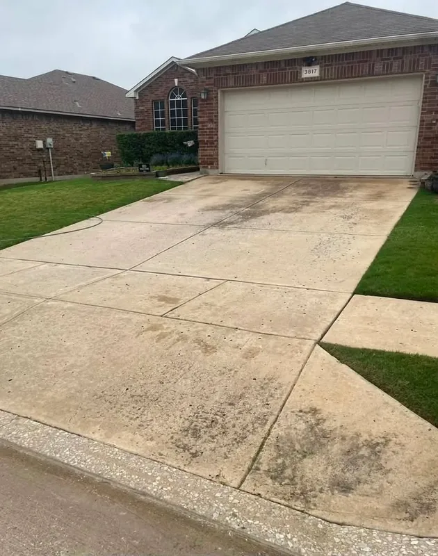 Front driveway with dark stains and dirt before pressure washing
